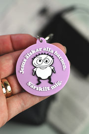 Nyckelring i silikon: Jesus älskar alla barnen (lila)